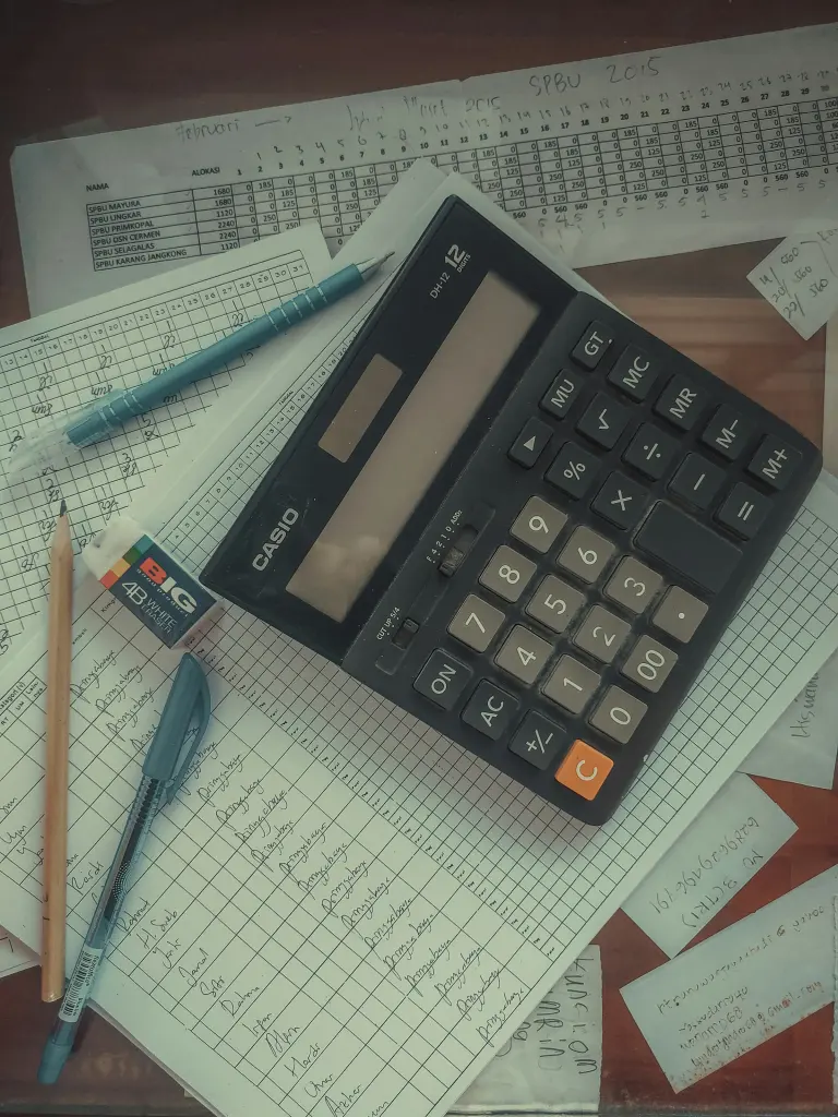Calculadora sobre un montón de facturas y papeles